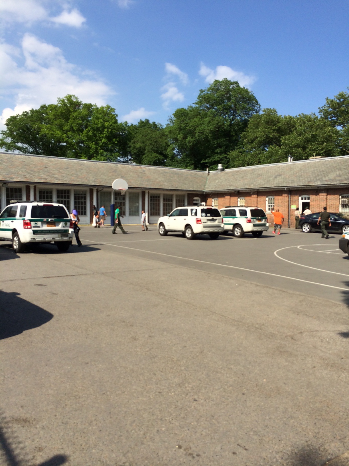 Some Residents Try to Play Basketball, Even with the Cars in the Way